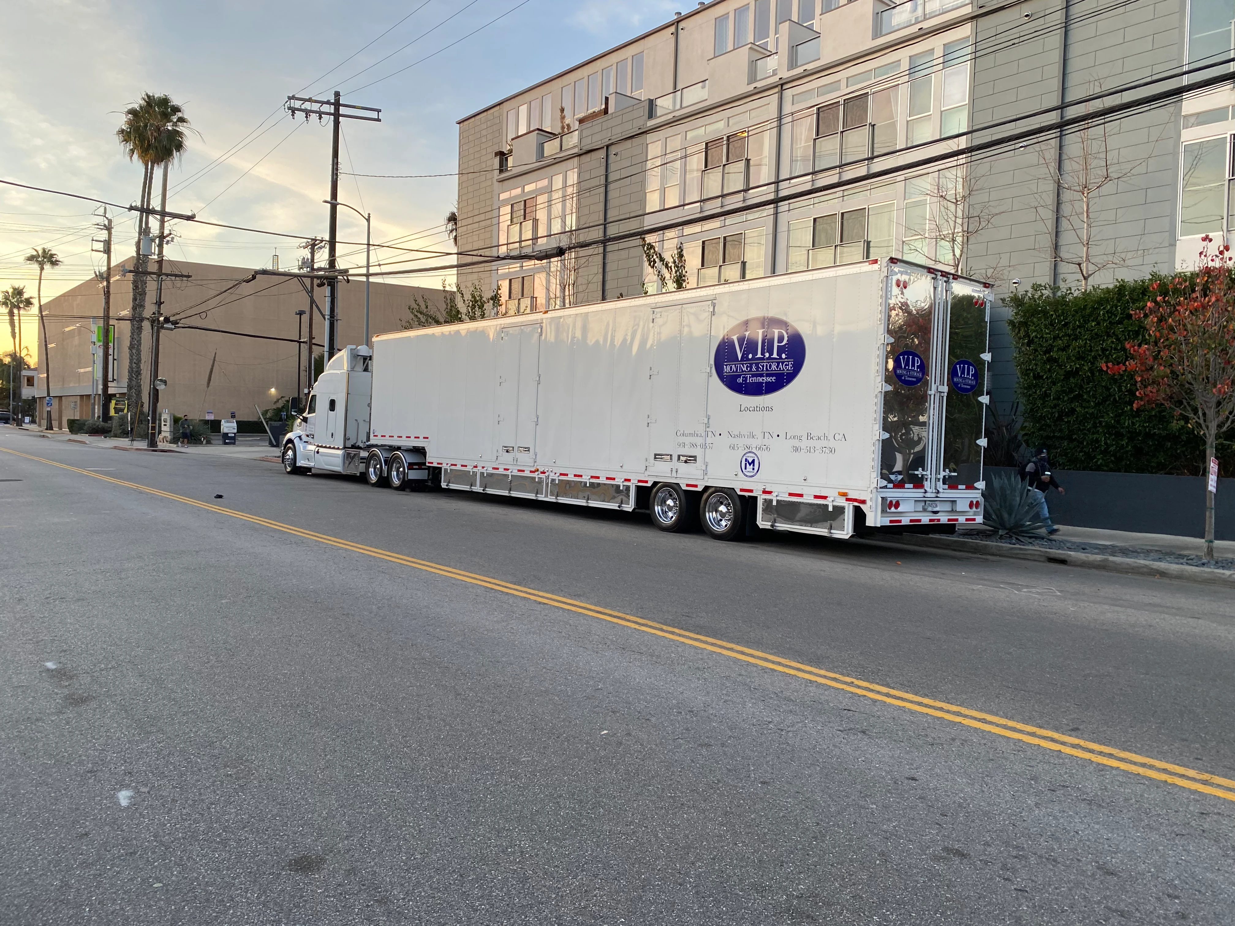 VIP truck on city street with palm trees